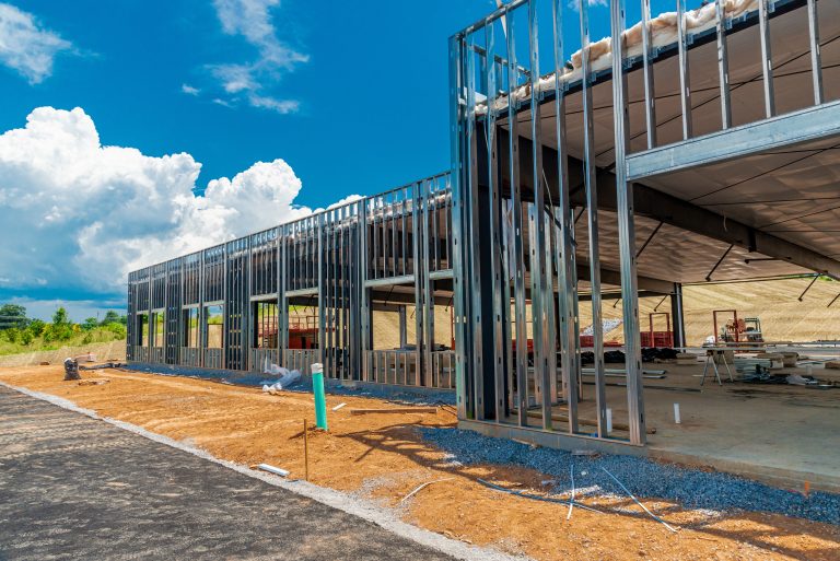Horizontal shot of the metal framework for a new commercial building under construction.