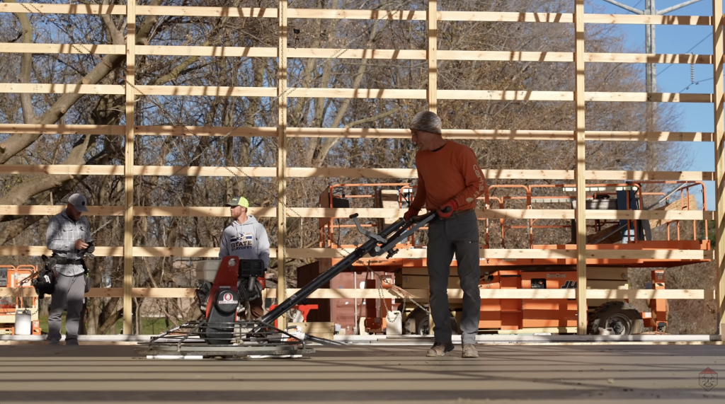 The concrete is smoothed with a fresno trowel, helping create a consistent surface across the shop floor.